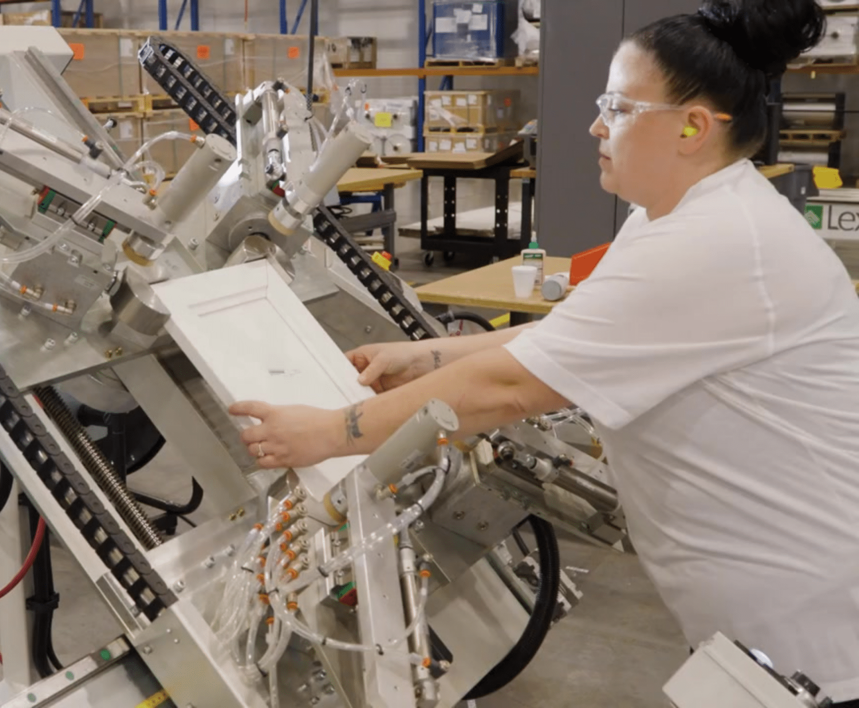 Woman removing cabinet door from machine